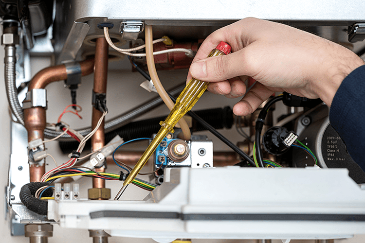 A furnace is tinkered with. How Does My Gas Furnace Work?